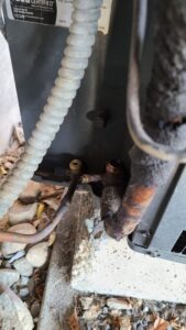 Close-up of refrigerant lines and valves on an outdoor HVAC unit serviced by Dave's Heating & Air Conditioning in Yakima, WA.