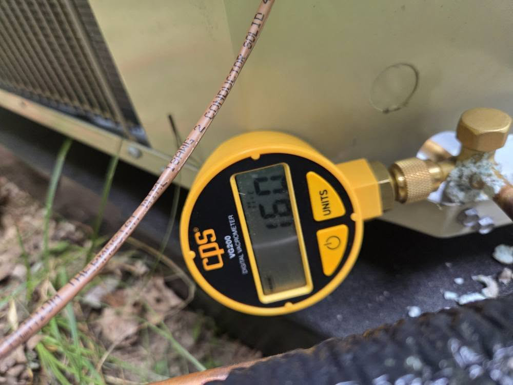 A digital vacuum gauge checking refrigerant pressure on an HVAC unit by Orchard Heating-Cooling and Sheet Metal in Stow, OH.