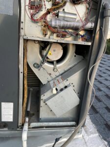 Close-up of the blower fan and internal components inside a rooftop HVAC unit by Kaluas HVAC Mechanical Services in Phoenix, AZ