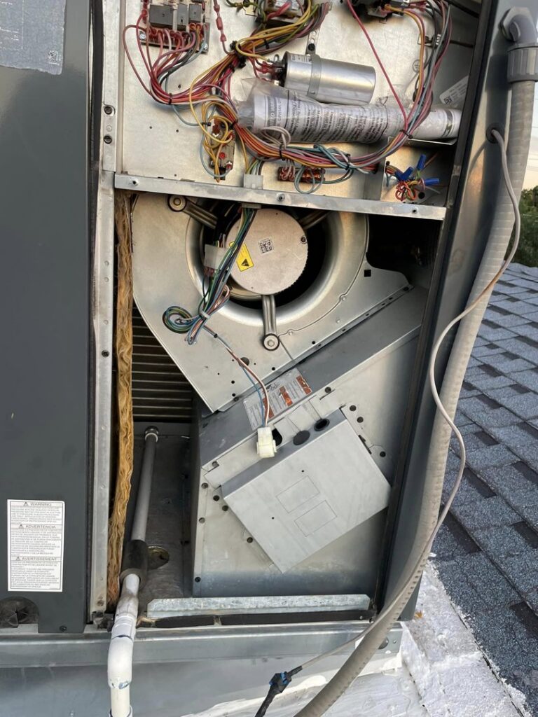 Close-up of the blower fan and internal components inside a rooftop HVAC unit by Kaluas HVAC Mechanical Services in Phoenix, AZ
