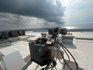 An HVAC technician's tools on a commercial rooftop unit, performing service for Whitleys Heating and Air in Jacksonville, FL.