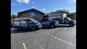 A fleet of branded HVAC service vehicles parked outside the My HVAC Guy office in North Canton, OH.