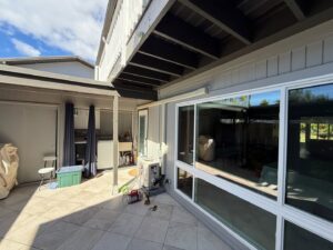 An HVAC technician performing service on an outdoor mini-split unit for Air Masters, Inc. in Port Orchard, WA.