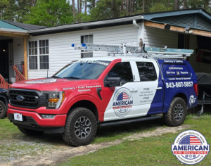 A branded American Air Solutions HVAC service truck with ladders parked outside a home in Summerville, SC, ready for a job.