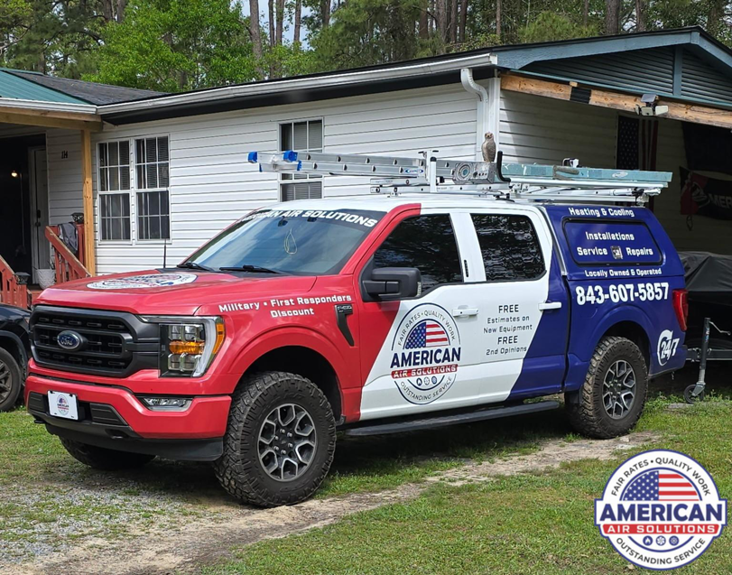 A branded American Air Solutions HVAC service truck with ladders parked outside a home in Summerville, SC, ready for a job.