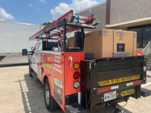 Utility truck loaded with ladders and HVAC equipment, ready for service by Benavidez Heating & Air Conditioning In, Arlington, TX.