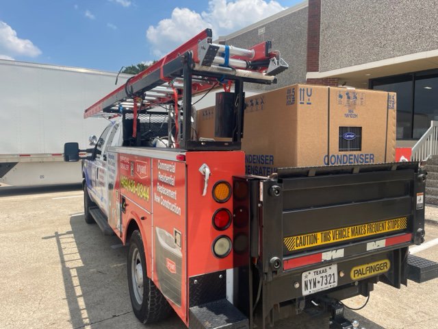 Utility truck loaded with ladders and HVAC equipment, ready for service by Benavidez Heating & Air Conditioning In, Arlington, TX.