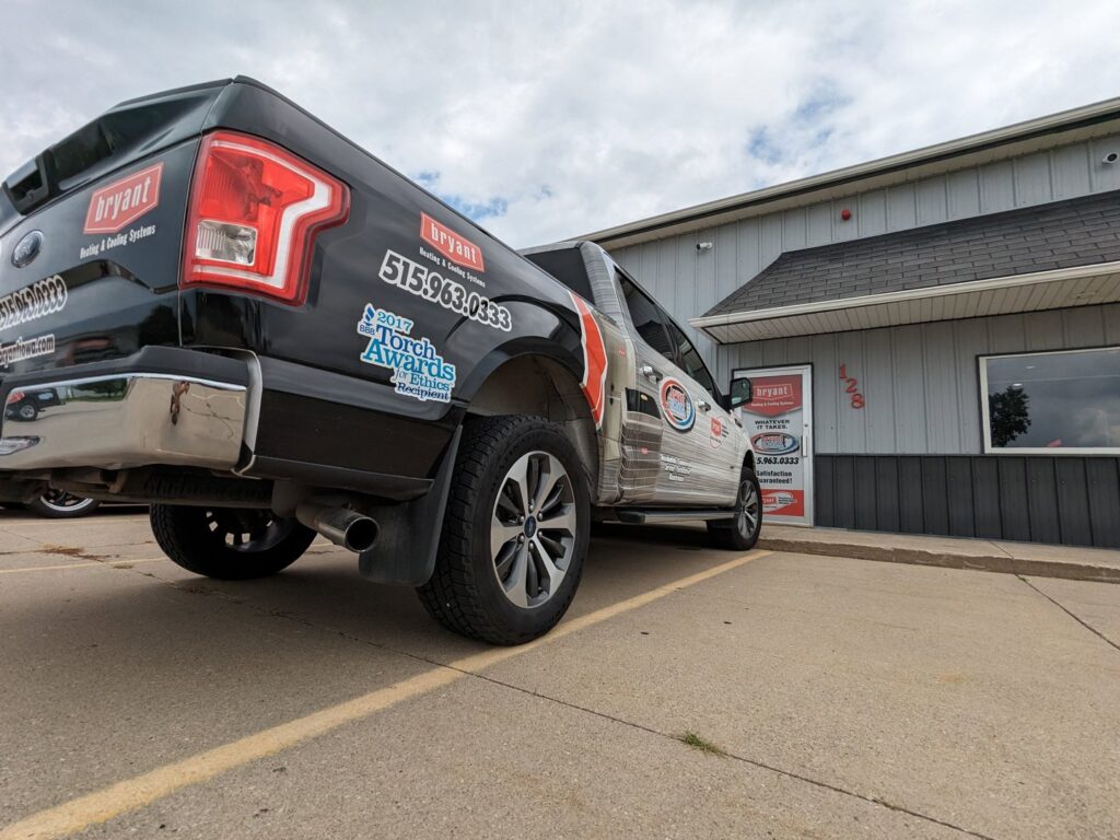 A branded HVAC service truck parked outside the business for Marie Keding Bryant Iowa Heating and Cooling in Ankeny, IA.