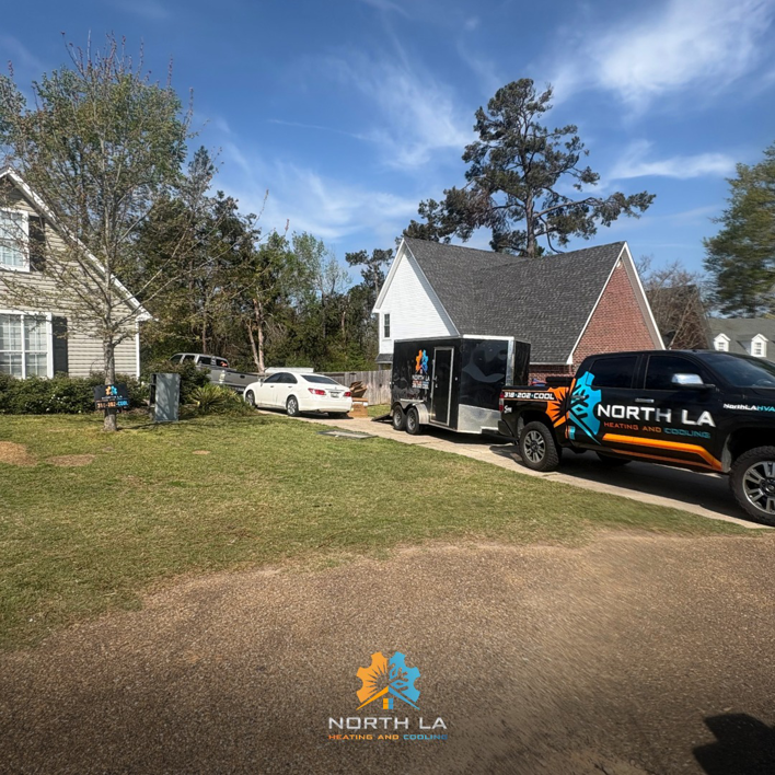 North LA Heating and Cooling service truck and trailer parked at a residential home in Monroe, LA, ready for an HVAC job.