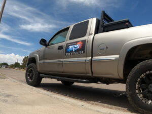 Side view of a One Way Heating And Cooling, LLC service truck with branding in Horizon City, TX.