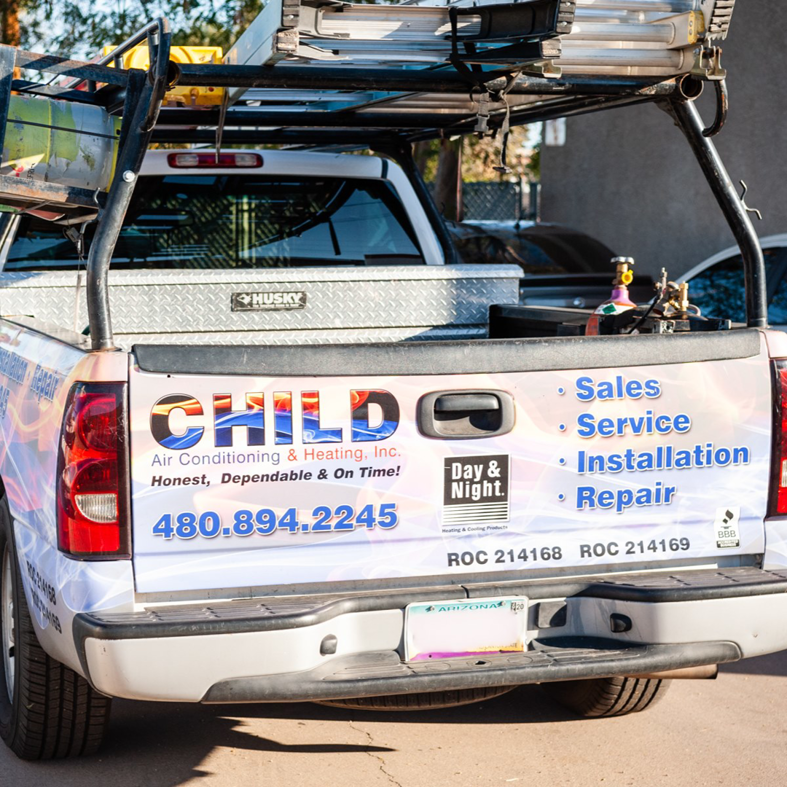 The back of a Child Air Conditioning & Heating Inc. service truck loaded with HVAC tools and equipment in Mesa, AZ.