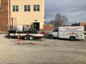 An HVAC service truck with geothermal ground source heat exchanger equipment on a trailer for Environmental Loop Service in Tulsa, OK.
