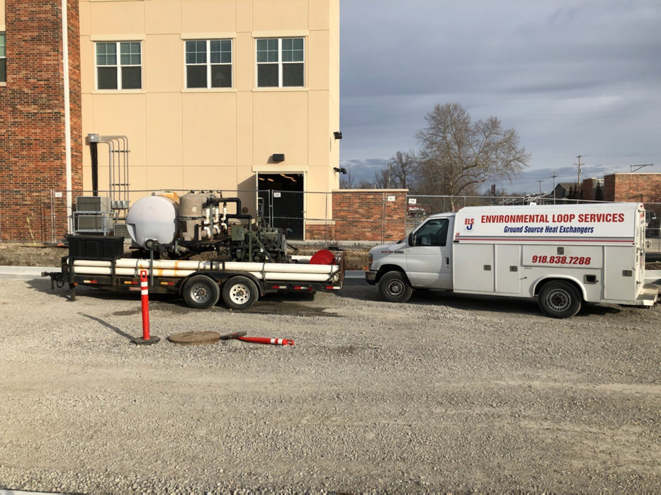 An HVAC service truck with geothermal ground source heat exchanger equipment on a trailer for Environmental Loop Service in Tulsa, OK.
