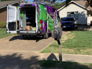 A Hendrix Heating & Air service van with open doors, showing tools and equipment at a job site in Newport News, VA.