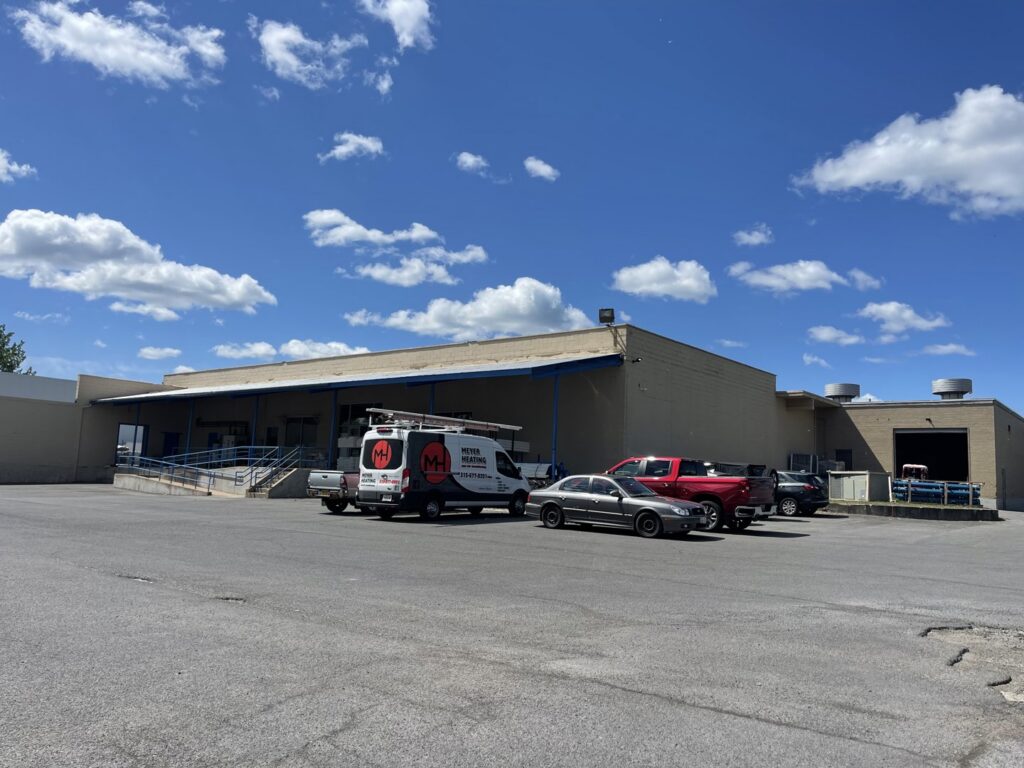 An HVAC service van from Meier Heating & Cooling parked outside a commercial building, representing VP Supply Corporation in Rochester, NY.