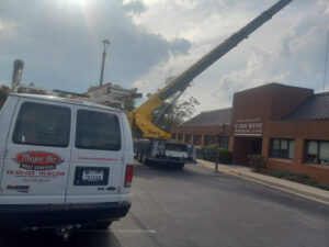 A Major Air HVAC Services van at a commercial job site with a crane in Salisbury, MD.