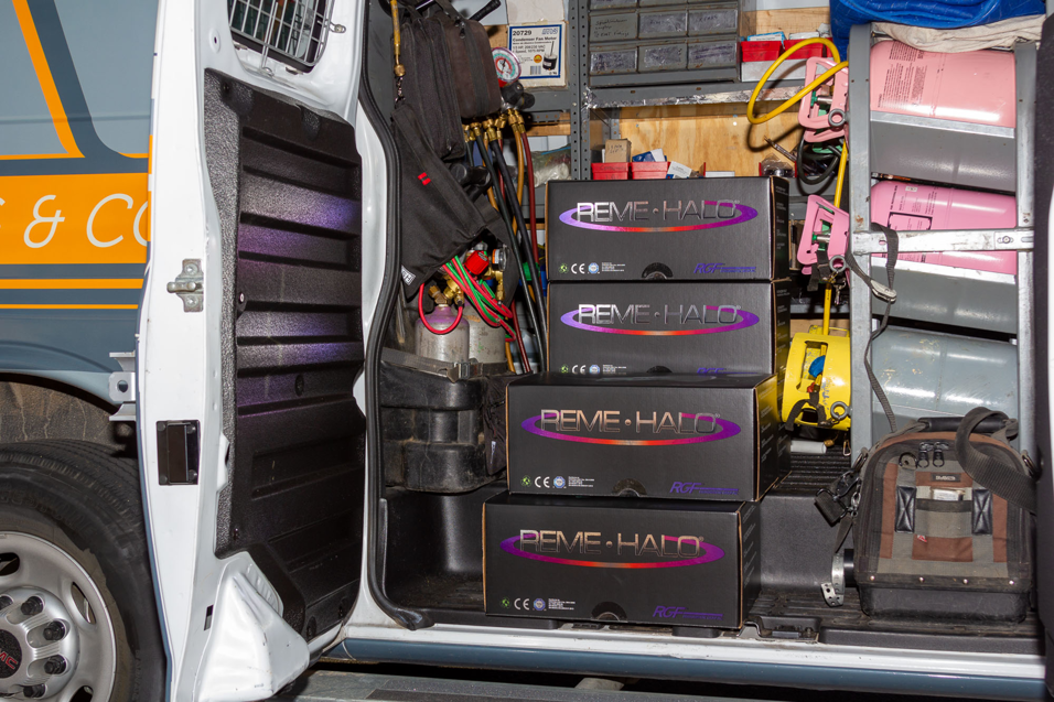 Interior of an HVAC service van with tools, refrigerant tanks, and REME-HALO boxes for AVI Heating & Cooling in Surprise, AZ