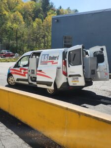 A U.S. Boiler Company HVAC service van with its side door open, revealing equipment inside, for Thermoflo Equipment in Pittsburgh, PA
