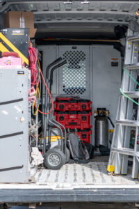 The organized interior of a Fix It Now Heating and Cooling service van, showing various tools and equipment for HVAC jobs in Thornton, CO