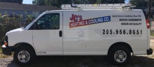 A white service van with JC's Heating and Cooling Co. branding and ladders, ready for HVAC jobs in Irondale, AL.