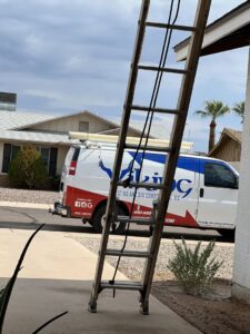 A Viking Heating and Air Conditioning, LLC service van with a ladder leaning against a residential home in Chandler, AZ, indicating a job in progress