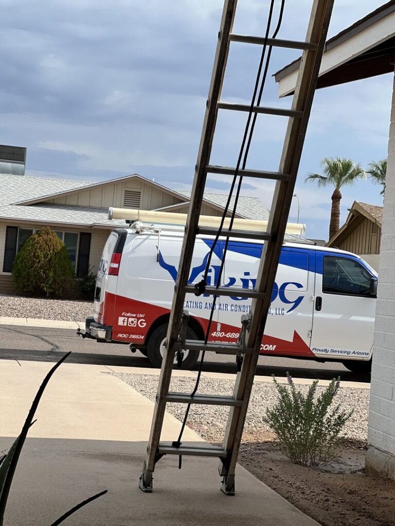 A Viking Heating and Air Conditioning, LLC service van with a ladder leaning against a residential home in Chandler, AZ, indicating a job in progress