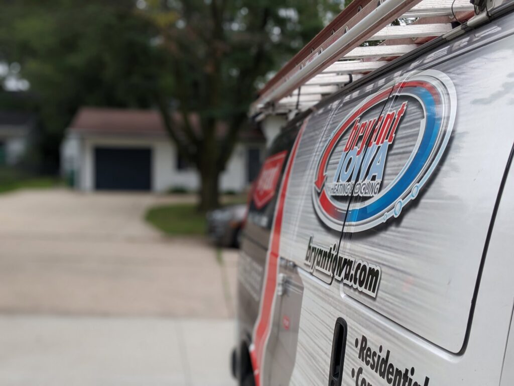 Close-up of the branded service van with the Marie Keding Bryant Iowa Heating and Cooling logo and ladder in Ankeny, IA.