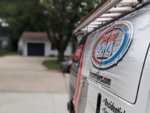 Close-up of the branded service van with the Marie Keding Bryant Iowa Heating and Cooling logo and ladder in Ankeny, IA.
