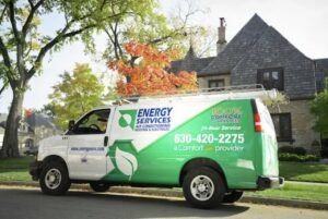 An Alan Energy Services HVAC service van parked in front of a residential home in Naperville, IL