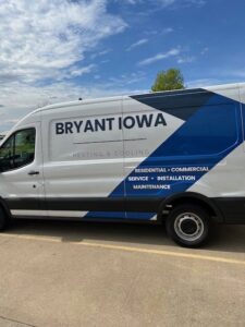 A modern branded HVAC service van for Marie Keding Bryant Iowa Heating and Cooling in Ankeny, IA.