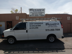 A white Bernie's Heating and Cooling service van with a ladder on the roof, ready for HVAC jobs in El Paso, TX.
