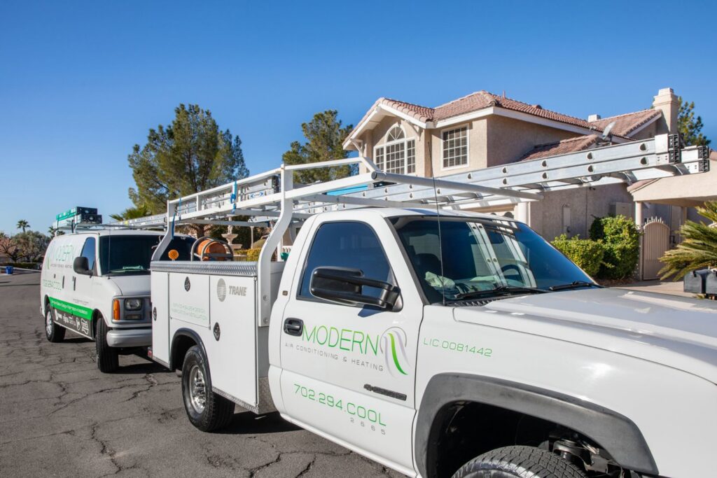 Modern Air Conditioning & Heating service van and truck parked, ready for HVAC jobs in Boulder City, NV.