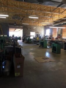 Spacious interior of the HVAC sheet metal fabrication shop at Carlsbad Heating & Cooling in Carlsbad, NM, showing various equipment.