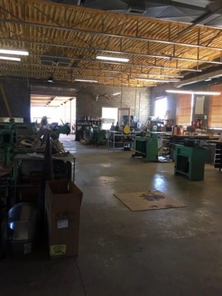 Spacious interior of the HVAC sheet metal fabrication shop at Carlsbad Heating & Cooling in Carlsbad, NM, showing various equipment.