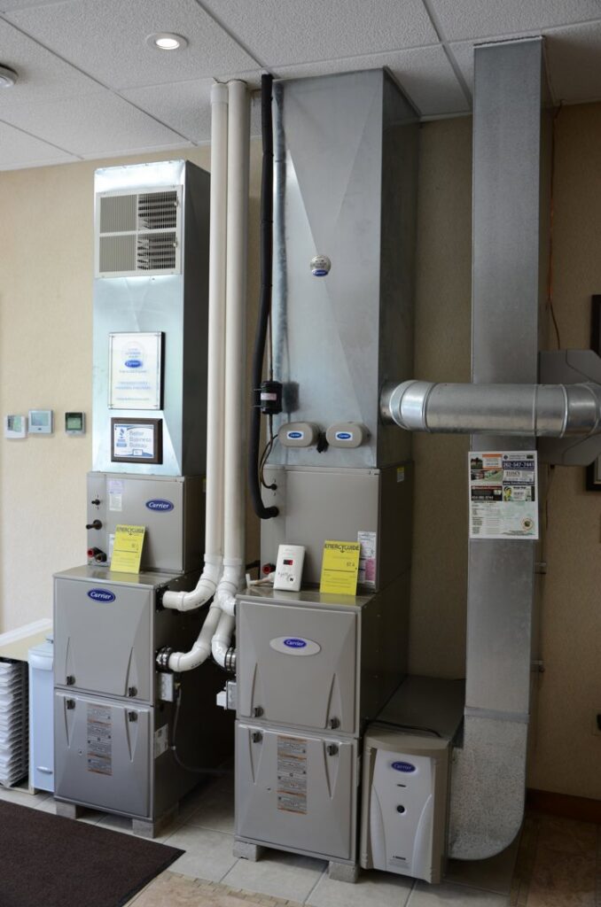 A showroom display of various Carrier furnaces and HVAC systems at Tom's Heating Service in Waukesha, WI.