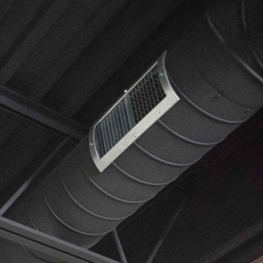 A close-up view of an HVAC spiral duct with an air vent installed by Pepeta Service Inc. in Clayton, DE