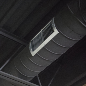A close-up view of an HVAC spiral duct with an air vent installed by Pepeta Service Inc. in Clayton, DE