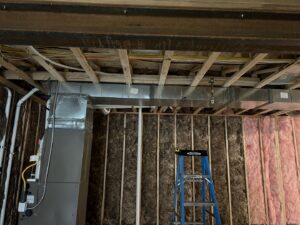 An HVAC system and ductwork installation in a basement under construction by R&R Mechanical Services in Greeley, CO.