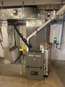 A complete HVAC system with a furnace, ductwork, and tankless water heater installed by Air We Are in Toms River, NJ.