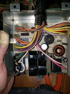 A detailed view of an HVAC system circuit board with various components and wiring by Thin Air Heating & Cooling Repair in Arvada, CO.