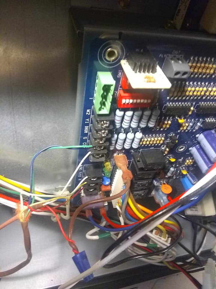 A close-up view of an HVAC system control board with intricate wiring by Bart Fey HVAC and Plumbing LLC in West Jefferson, OH.