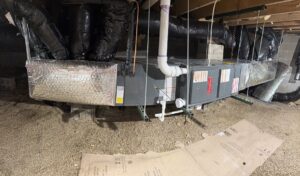 A large HVAC system with furnace and ductwork installed in a crawl space by Buckeye Mechanical Construction in Columbus, OH.