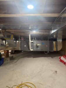 A comprehensive HVAC system with extensive ductwork installed in a basement by Northern Peak Heating & Cooling in Bozeman, MT.