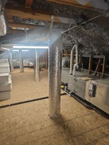 An HVAC system with ductwork and an air handler unit being installed in an attic by Fusion Heat and Air in Fort Smith, AR.
