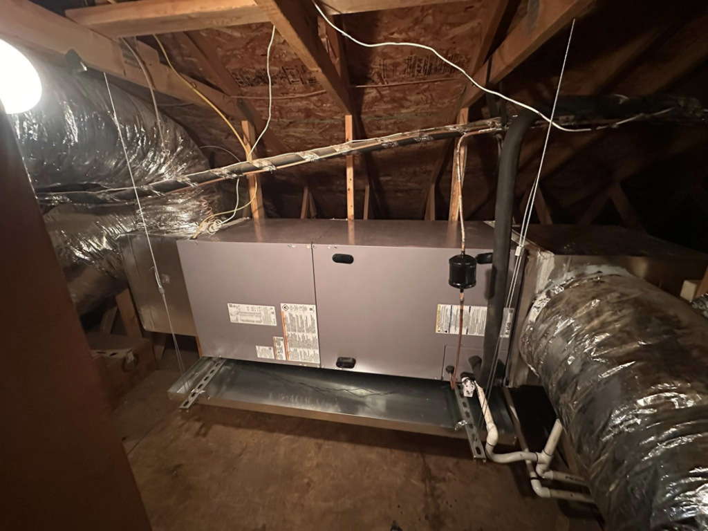 An HVAC system installation with an air handler and ductwork in an attic by Weather Masters, Inc. in Mesa, AZ.