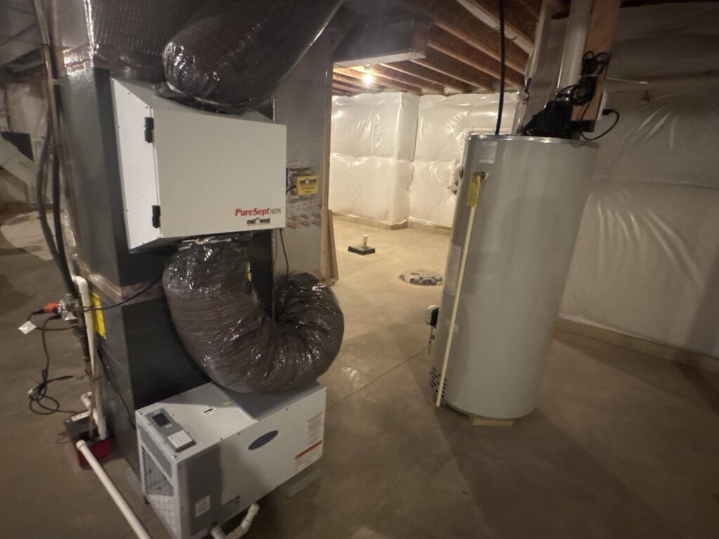 A complete HVAC system with furnace, air purifier, and water heater installed in a basement by One Hour Heating & Air Conditioning of Lancaster, PA.