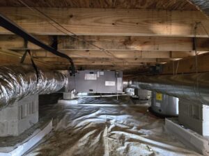 A newly installed HVAC system with ductwork in a residential crawl space by Aces of Air Inc. in Georgetown, KY.