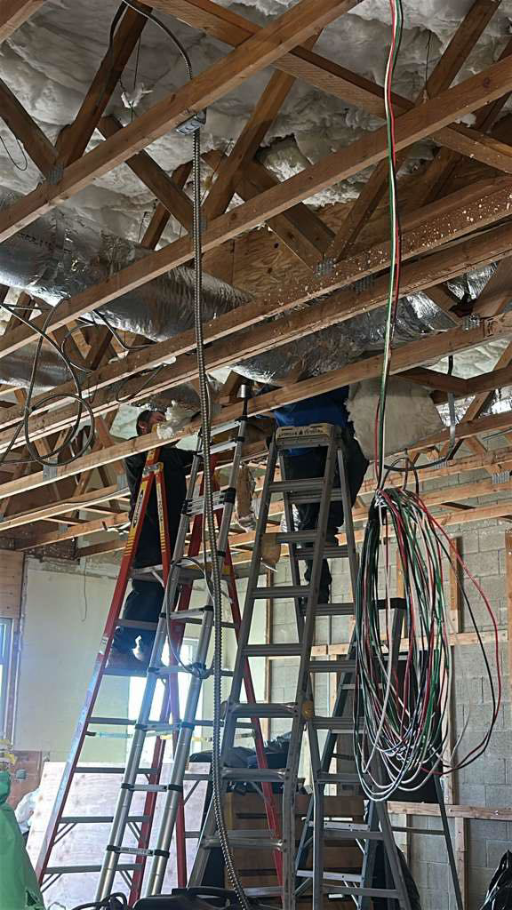 A crew of HVAC technicians installing a new system in a building under construction for Rosales Aire Inc. in Anaheim, CA.