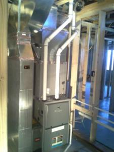 HVAC system installation with furnace, ductwork, and piping in new construction by Northwest Heating and Air Conditioning in Helena, MT.