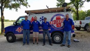 The HVAC team standing with their service van equipped with ladders for M.D. Repair Heating and Cooling in Oak Grove, MO.